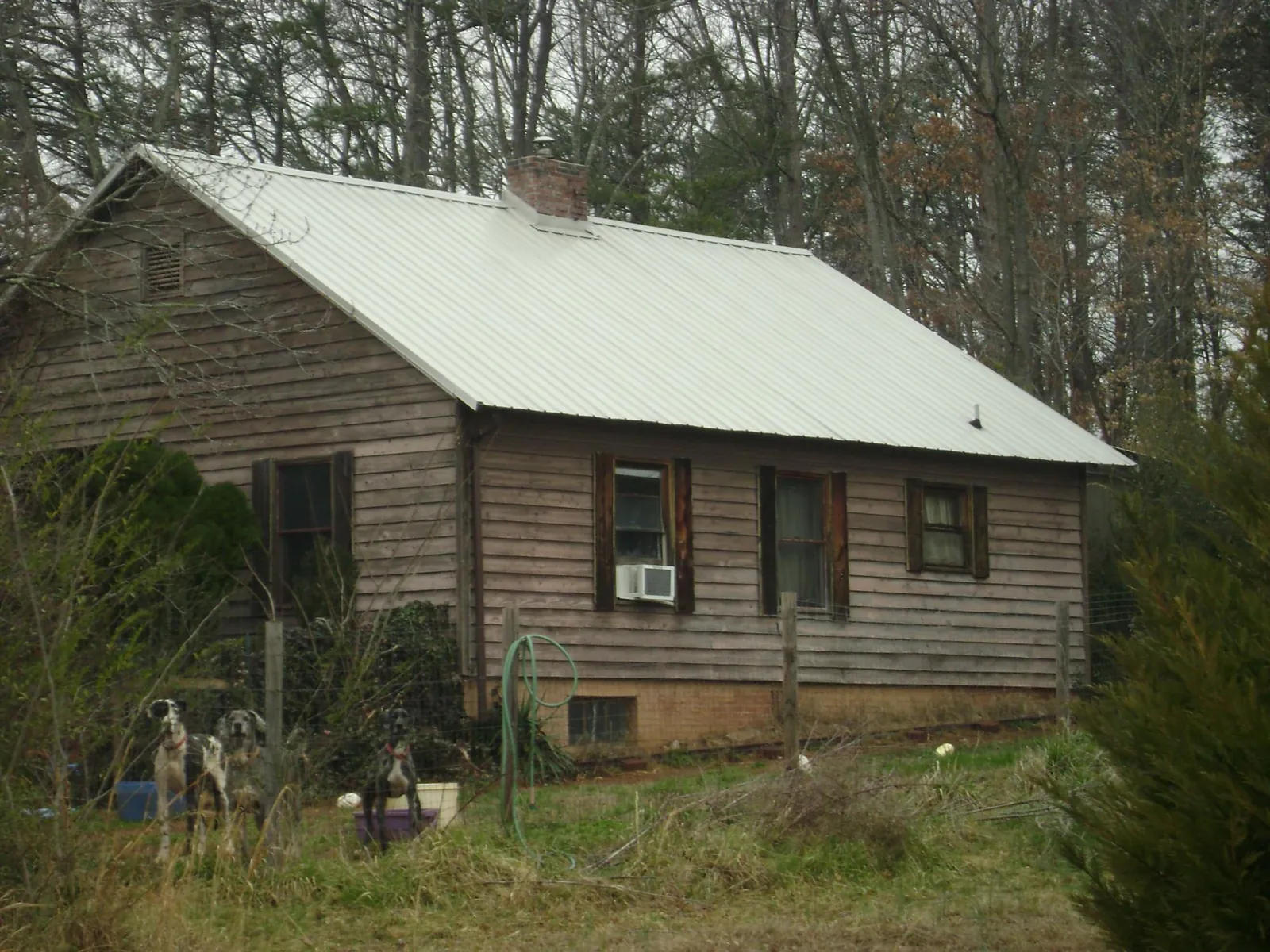 White metal roof on an old wood sided farmhouse, from a Metal Roof Installation job in Hagerstown